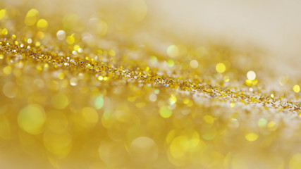 Wall Mural - Lights on gold with star bokeh background.Gold celebration background for anniversary, New Year Eve, Christmas, falling coins, wedding or birthday