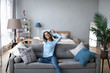 © BestForYou - Happy casual beautiful woman sitting on a sofa at home.