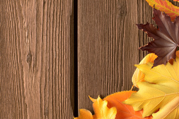 Wall Mural - Flat lay autumn background from old rustic wooden brown planks and yellow autumn fallen leaves with empty place for text. Design template, mock up