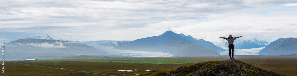 Panorama picture of asian woman solo travel enjoy at nature on the top mountain with Skaftafellsjokull glacier as a Background in Iceland - obrazy, fototapety, plakaty 