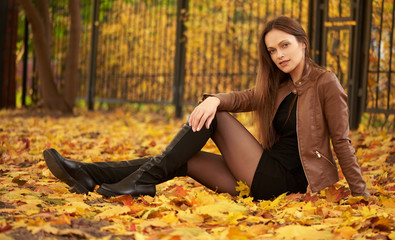 Wall Mural - Autumn portrait of a beautiful woman in the park