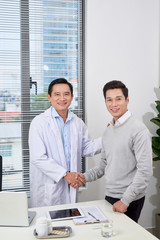 Wall Mural - Smiling medical doctor with  man. Health care.