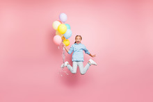 Full Length Body Size Photo Of Cheerfu Positive Cute Nice Screaming Funny Comic Girl Holding Balloons With Hands Shouting Flying Jumping In Blue Sweatshirt Sweater Hoodie Jeans Denim Isolated Pastel