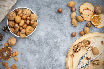 Wall Mural - Mix of nuts - hazelnuts, almonds, walnuts in a basket over dark bckground. Healthy super food. Top view with copy space.