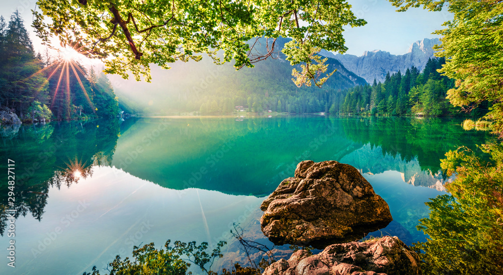 Impressive morning view of Fusine lake. Attractive summer scene of Julian Alps with Mangart peak on background, Province of Udine, Italy, Europe. Traveling concept background. - obrazy, fototapety, plakaty 