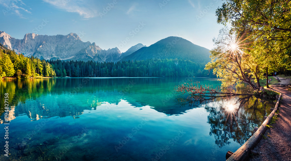 Colorful summer view of Fusine lake. Bright morning scene of Julian Alps with Mangart peak on background, Province of Udine, Italy, Europe. Traveling concept background. - obrazy, fototapety, plakaty 
