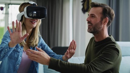 Wall Mural - Modern couple using virtual reality simulator