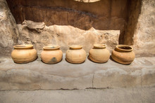 Ancient Clay Pots. Row Of Historical Clay Pots Sit On The Stone Wall Of An Adobe In Tumacacori National Park.