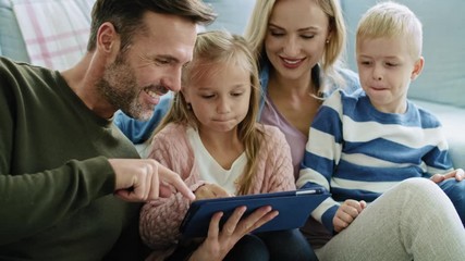 Wall Mural - Happy family using technology in living room