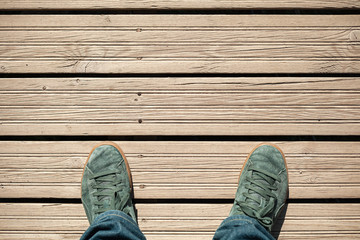 Green suede shoes on wooden floor