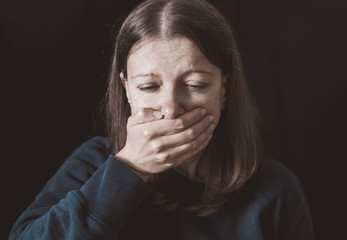 Wall Mural - Woman with hands closed mouth. Female violence concept. Restriction and inability to speak.