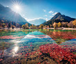 © Andrew Mayovskyy - Gorgeous morning view of Jasna lake. Stunning autumn scene of Julian Alps, Gozd Martuljek location, Slovenia, Europe. Wonderful landscape of Triglav National Park. Traveling concept background.
