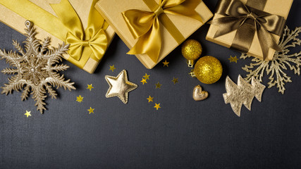 Wall Mural - Golden gift boxes with shiny brown satin bow and christmas decorations