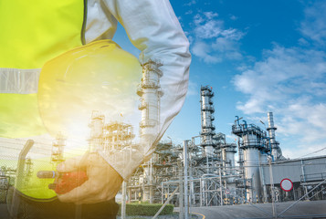 Double exposure of engineers holding walkie talkie are working orders the oil and gas refinery plant and offshore drilling. Industry petrochamical concept image.