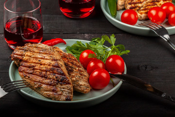 Wall Mural - Tasty grilled chicken with fresh tomatoes on a dish