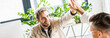 © LIGHTFIELD STUDIOS - panoramic shot of two young businessmen giving high five in office
