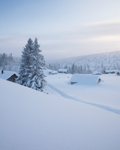 Log Cabins Covered In Snow