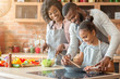 © Prostock-studio - Afro parents teaching their daughter how to cook