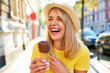 © Westend61 - Carefree young woman enjoying an ice cream in the city