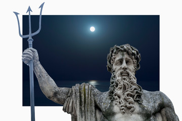 The mighty god of the sea and oceans Neptune (Poseidon) against sea at night. The ancient statue.