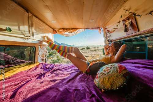 Woman Relaxing On Bed In Camper Van Kaufen Sie Dieses Foto