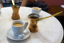 Traditional Greek Coffee Served With Brass Pot And Sweet Loukoumi. Taken In Athens
