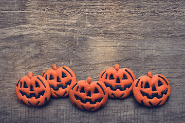 Wall Mural - Halloween gingerbread cookies on wooden background.