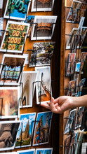 Tourist Hand Shopping For Postcards In Barcelona