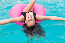 Smiling 13 Year Old Girl In Colorful Floatie