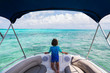 © Mint Images - Rear view of boy standing on boat