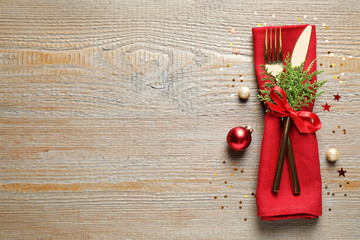 Cutlery set on wooden table, top view with space for text. Christmas celebration