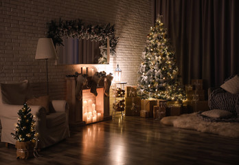 Sticker - Stylish interior with beautiful Christmas tree and artificial fireplace at night