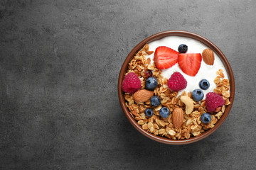 Wall Mural - Tasty homemade granola served on grey table, top view with space for text. Healthy breakfast