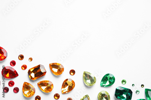 Fotografía Different beautiful gemstones on white background, top view