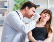 © Elnur - Doctor checking patients ear during medical examination