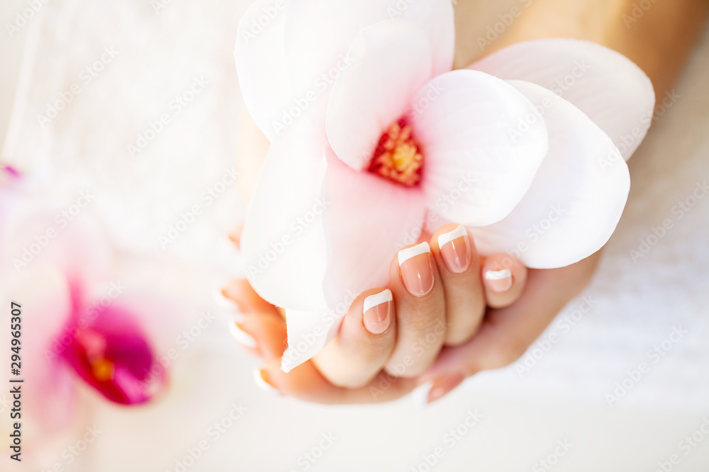 Nails care. Beautiful woman's nails with french manicure, in beauty studio - obrazy, fototapety, plakaty 