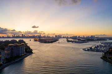 Wall Mural - Twilight aerial Miami scene including water port and islands view of Downtown in far background