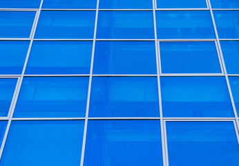 Square blue windows of the business center. Theme of modern geometric architecture and urbanization