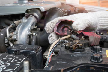 Fix car a wrench on hand with engine car on background. 