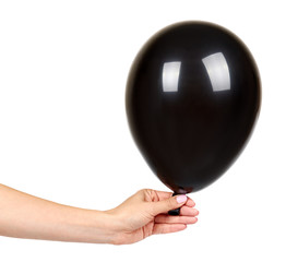 Hand with black inflateble balloon, party event decoration, glossy ball.