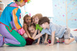© Oksana Kuzmina - Clown entertaining preschool kids on birthday party. Games with animator