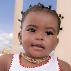 Portrait of an adorable baby girl smiling, nine months old