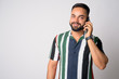 © Ranta Images - Portrait of happy young bearded Indian man talking on the phone