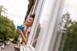 Woman looking out the window and drinking coffee