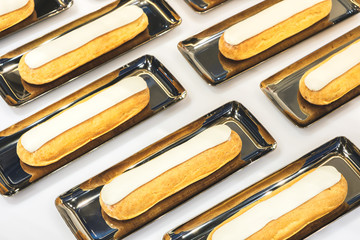 Poster - eclairs on golden saucer trays in an expensive luxury restaurant