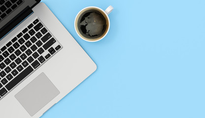 Wall Mural - Laptop and coffee mug copy space on blue table background, 3d rendering