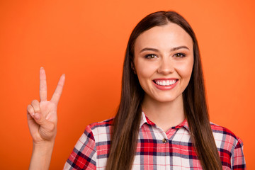 Poster - Close-up portrait of nice attractive lovely pretty cheerful cheery straight-haired girl showing v-sign good mood having fun isolated on bright vivid shine vibrant orange color background