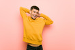 © Asier - Young hispanic man stretching arms, relaxed position.