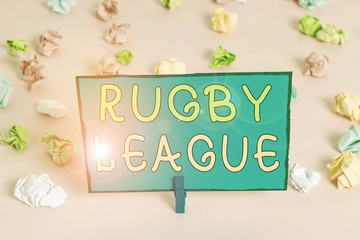 Writing note showing Rugby League. Business concept for form of rugby football played between teams of 13 players Colored crumpled papers empty reminder pink floor background clothespin