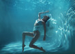 Fashion art photo of beautiful woman swimming and posing underwater